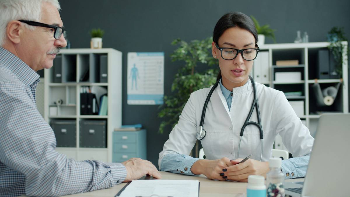 how to work in healthcare administration: woman reviewing electronic health records on dual monitors in hospital office